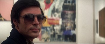 Movie still from “Dressed to Kill” (1980), directed by Brian De Palma – A person wearing sunglasses; Close Up shot, Low angle