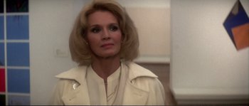 Movie still from “Dressed to Kill” (1980), directed by Brian De Palma – A person wearing a white jacket; Close Up shot, Low angle