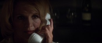 Movie still from “Dressed to Kill” (1980), directed by Brian De Palma – A person talking on a phone; Close Up shot, Low angle