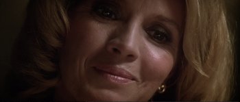 Movie still from “Dressed to Kill” (1980), directed by Brian De Palma – A woman's face in a dimly - lit room; Extreme Close Up shot, Low angle
