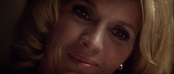 Movie still from “Dressed to Kill” (1980), directed by Brian De Palma – A woman's face with dark eyes; Extreme Close Up shot, Overhead angle