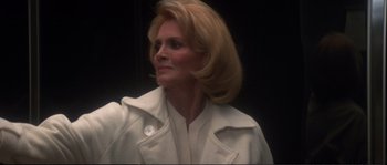 Movie still from “Dressed to Kill” (1980), directed by Brian De Palma – A person wearing a white jacket; Close Up shot, Low angle