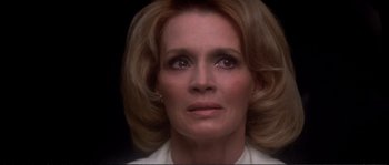 Movie still from “Dressed to Kill” (1980), directed by Brian De Palma – A person wearing a white shirt; Close Up shot, Low angle