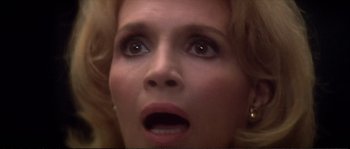 Movie still from “Dressed to Kill” (1980), directed by Brian De Palma – A woman's face as she looks upward; Extreme Close Up shot, Low angle