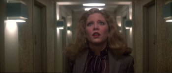 Movie still from “Dressed to Kill” (1980), directed by Brian De Palma – A person wearing a suit and tie; Close Up shot, Low angle