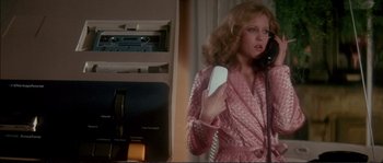 Movie still from “Dressed to Kill” (1980), directed by Brian De Palma – A woman holding a phone up to her ear; Medium shot, Low angle