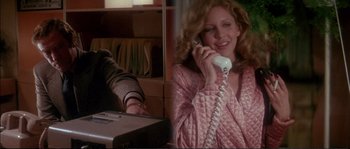 Movie still from “Dressed to Kill” (1980), directed by Brian De Palma – A woman talking on a phone in a room; Medium shot, Low angle