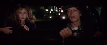 Movie still from “Dressed to Kill” (1980), directed by Brian De Palma – A man and a woman sitting in the back of a car at night; Close Up shot, Over the shoulder angle