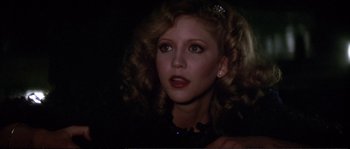 Movie still from “Dressed to Kill” (1980), directed by Brian De Palma – A person with curly hair; Close Up shot, Low angle