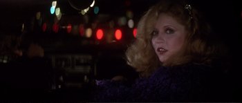 Movie still from “Dressed to Kill” (1980), directed by Brian De Palma – A woman in a purple sweater in a car at night; Close Up shot, Over the shoulder angle