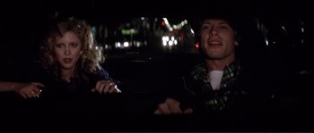 Movie still from “Dressed to Kill” (1980), directed by Brian De Palma – A man and a woman sitting in the back seat of a car; Close Up shot, Over the shoulder angle