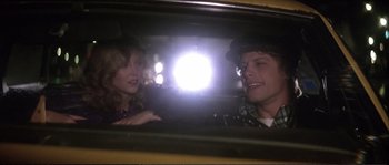 Movie still from “Dressed to Kill” (1980), directed by Brian De Palma – A man and a woman in the back seat of a car; Close Up shot, Over the shoulder angle