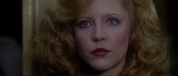 Movie still from “Dressed to Kill” (1980), directed by Brian De Palma – A woman's face with red lipstick; Close Up shot, Low angle