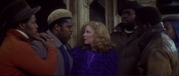 Movie still from “Dressed to Kill” (1980), directed by Brian De Palma – A man and a woman standing next to each other; Medium shot, Over the shoulder angle