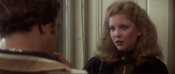 Movie still from “Dressed to Kill” (1980), directed by Brian De Palma – A woman in a black dress looking at a man in a white shirt; Close Up shot, Over the shoulder angle