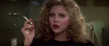 Movie still from “Dressed to Kill” (1980), directed by Brian De Palma – A person holding a cigarette in her mouth; Close Up shot, Low angle