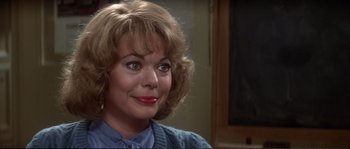 Movie still from “Dressed to Kill” (1980), directed by Brian De Palma – A person wearing a blue shirt; Close Up shot, Over the shoulder angle