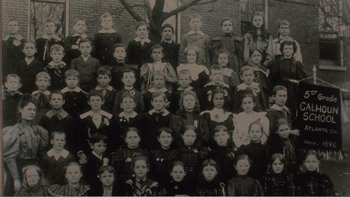 Movie still from “Driving Miss Daisy” (1989), directed by Bruce Beresford – An old photo of a group of children in front of a brick wall; Wide shot, Overhead angle