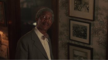 Movie still from “Driving Miss Daisy” (1989), directed by Bruce Beresford – An older man wearing a suit and a bow tie; Close Up shot, Low angle