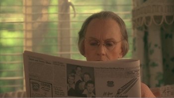 Movie still from “Driving Miss Daisy” (1989), directed by Bruce Beresford – An older woman reading a newspaper in a window; Close Up shot, Over the shoulder angle