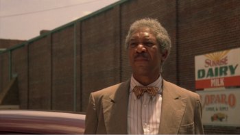 Movie still from “Driving Miss Daisy” (1989), directed by Bruce Beresford – An older man wearing a suit and a bow tie; Close Up shot, Low angle