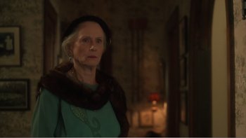 Movie still from “Driving Miss Daisy” (1989), directed by Bruce Beresford – An older woman wearing a green dress and a fur stole; Close Up shot, Over the shoulder angle