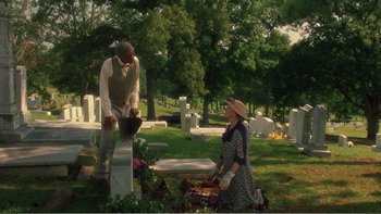 Movie still from “Driving Miss Daisy” (1989), directed by Bruce Beresford – A man and a woman standing in front of a grave; Wide shot, High angle