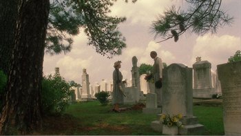 Movie still from “Driving Miss Daisy” (1989), directed by Bruce Beresford – A couple of people that are in a cemetery; Extreme Wide shot, Low angle