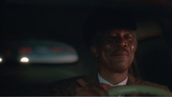 Movie still from “Driving Miss Daisy” (1989), directed by Bruce Beresford – A man sitting in the back seat of a car; Close Up shot, Low angle