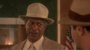 Movie still from “Driving Miss Daisy” (1989), directed by Bruce Beresford – An older man wearing a tan suit and a hat; Close Up shot, Low angle