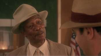 Movie still from “Driving Miss Daisy” (1989), directed by Bruce Beresford – An older man wearing a hat and a suit; Close Up shot, Low angle