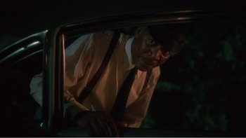 Movie still from “Driving Miss Daisy” (1989), directed by Bruce Beresford – An older man looking out of the window of a car at night; Close Up shot, Over the shoulder angle