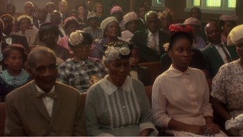 Movie still from “Driving Miss Daisy” (1989), directed by Bruce Beresford – A group of people sitting in a room; Medium shot, High angle