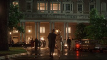 Movie still from “Driving Miss Daisy” (1989), directed by Bruce Beresford – A couple of people walking down a street at night; Extreme Wide shot, Low angle