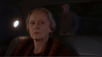 Movie still from “Driving Miss Daisy” (1989), directed by Bruce Beresford – An older woman sitting in a car looking at the camera; Close Up shot, Over the shoulder angle