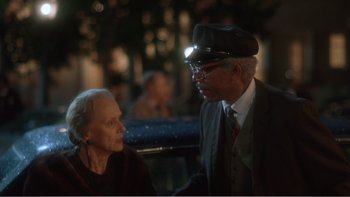 Movie still from “Driving Miss Daisy” (1989), directed by Bruce Beresford – An older man and a younger woman are talking together; Close Up shot, Over the shoulder angle