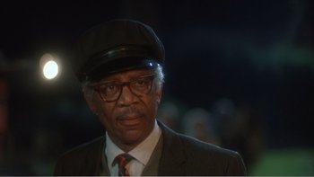 Movie still from “Driving Miss Daisy” (1989), directed by Bruce Beresford – An older man wearing a hat and a suit; Close Up shot, Low angle
