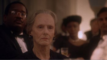 Movie still from “Driving Miss Daisy” (1989), directed by Bruce Beresford – An old woman with a bunch of people in the background; Close Up shot, Over the shoulder angle