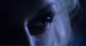 Movie still from “Drop Dead Gorgeous” (1999), directed by Michael Patrick Jann – A woman's eye with a blue light shining on it; Extreme Close Up shot, Overhead angle