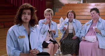 Movie still from “Drop Dead Gorgeous” (1999), directed by Michael Patrick Jann – A group of women sitting in a room eating food; Medium shot, Over the shoulder angle