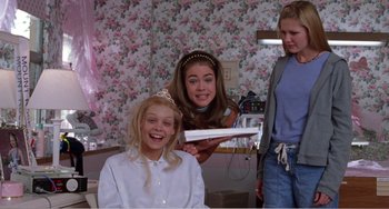 Movie still from “Drop Dead Gorgeous” (1999), directed by Michael Patrick Jann – A girl is getting her hair cut by two other girls; Medium shot, Low angle