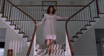 Movie still from “Drop Dead Gorgeous” (1999), directed by Michael Patrick Jann – A woman standing on the bottom of a set of stairs; Wide shot, Low angle