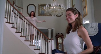Movie still from “Drop Dead Gorgeous” (1999), directed by Michael Patrick Jann – Two women are standing in front of a staircase; Medium shot, Low angle