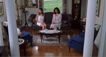 Movie still from “Drop Dead Gorgeous” (1999), directed by Michael Patrick Jann – Two women sitting on a couch in a living room; Wide shot, High angle