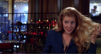 Movie still from “Drop Dead Gorgeous” (1999), directed by Michael Patrick Jann – A woman with blonde hair and a blue jacket; Close Up shot, Over the shoulder angle