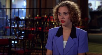Movie still from “Drop Dead Gorgeous” (1999), directed by Michael Patrick Jann – A woman with curly hair wearing a blue jacket; Medium shot, Over the shoulder angle