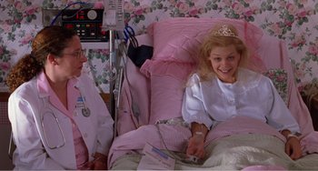 Movie still from “Drop Dead Gorgeous” (1999), directed by Michael Patrick Jann – A young girl in a hospital bed with a doctor; Medium shot, High angle
