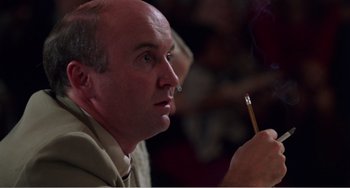 Movie still from “Drop Dead Gorgeous” (1999), directed by Michael Patrick Jann – A man with a cigarette in his mouth; Close Up shot, Low angle