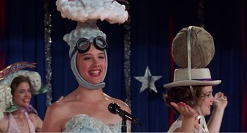 Movie still from “Drop Dead Gorgeous” (1999), directed by Michael Patrick Jann – A woman wearing a hat with a cloud on top of her head; Close Up shot, Low angle
