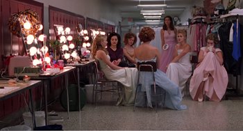 Movie still from “Drop Dead Gorgeous” (1999), directed by Michael Patrick Jann – A group of women sitting around a table in front of a mirror; Wide shot, High angle